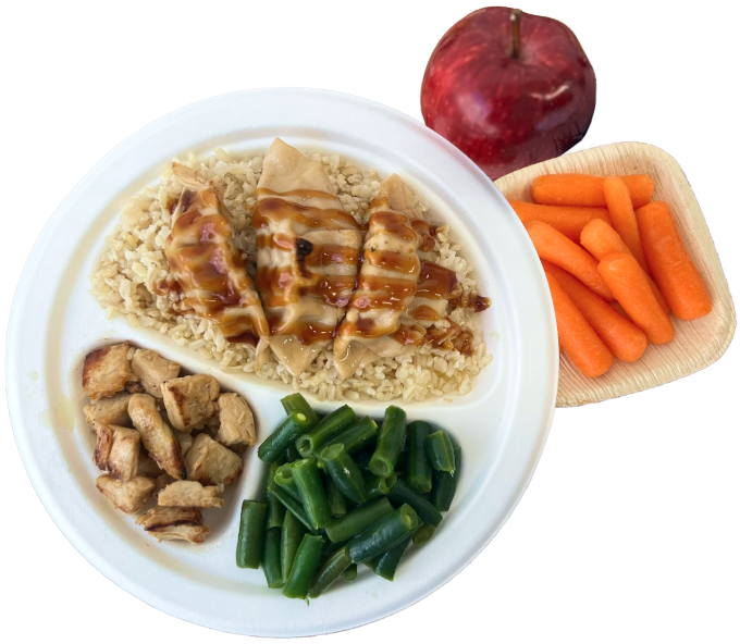 Plate of dumplings with green beans rice chicken carrots and an apple